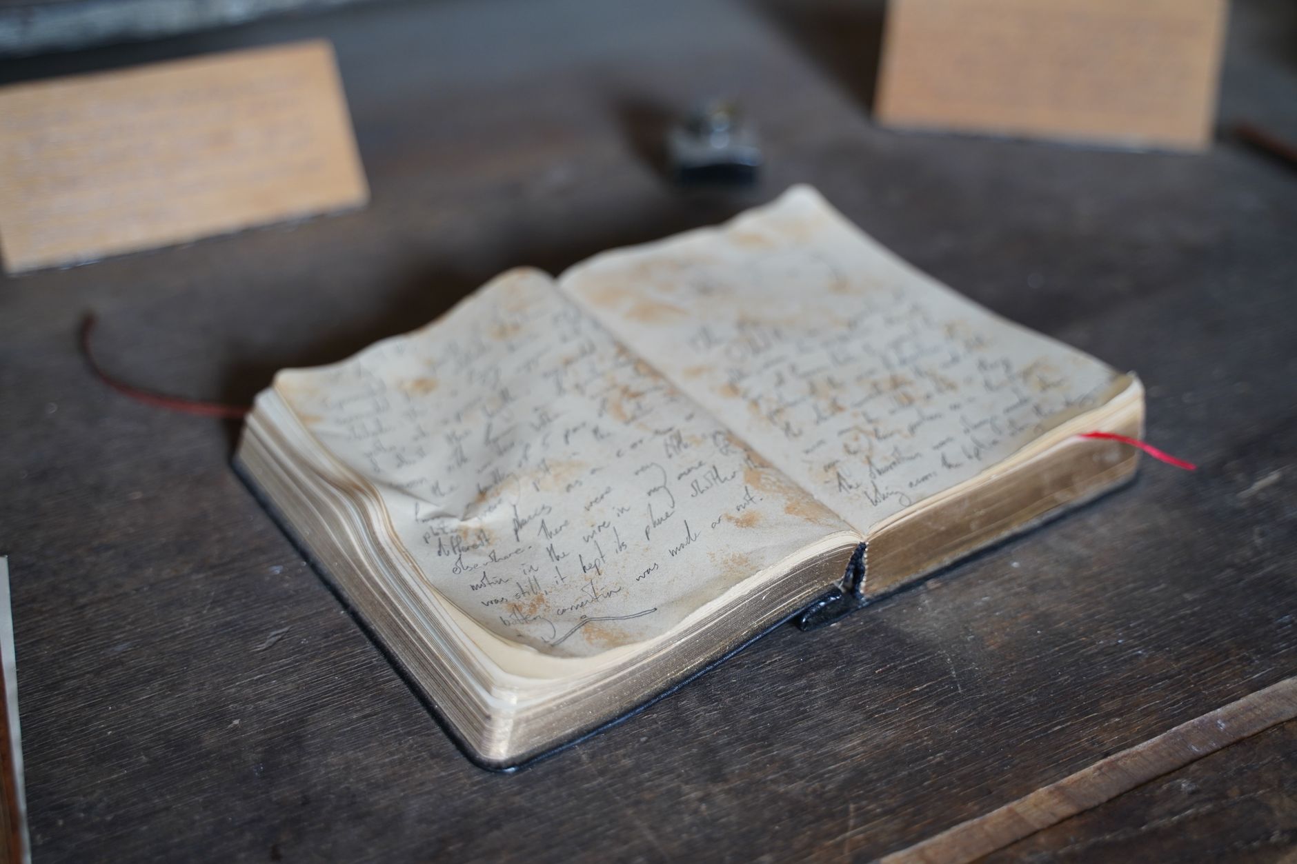 A quiet antique study setting with rustic journals and coffee